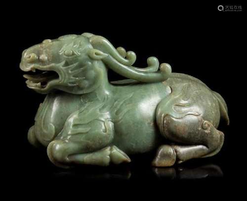 * A Celadon Jade Figure of a Recumbent Qilin Height 11