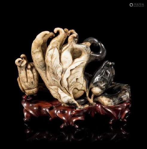 * A Chicken Bone and Black Jade Carving of a Buddha's