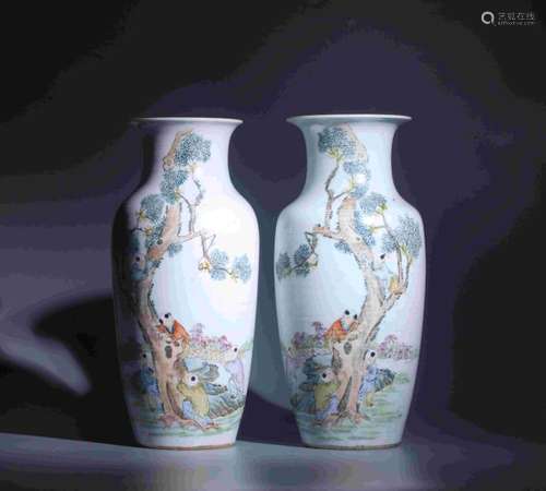 PAIR OF COLORED CHILDREN PAYING VASES