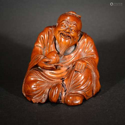 A CARVED HUANGYANG WOOD FIGURE