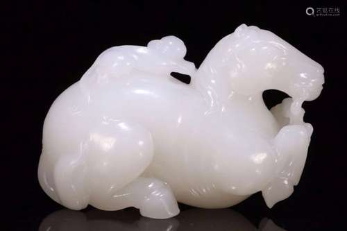 A HETIAN JADE CARVED FIGURE OF HORSEBACK RIDING