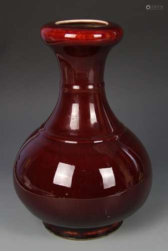 A OXBLOOD VASE WITH A FLARED OPENING