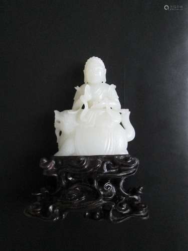 A HETIAN JADE FIGURE OF SITTED BUDDHA