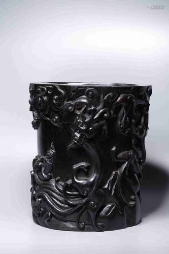 A WOODEN CARVED BRUSH POT