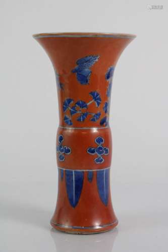 A RED GLAZED BEAKER VASE