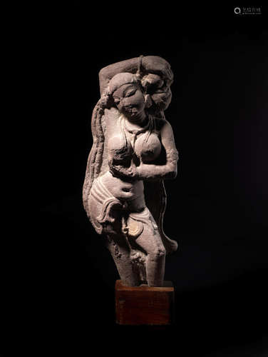 NORTH INDIA, 10TH/11TH CENTURY A RED SANDSTONE FIGURE OF A CELESTIAL BEAUTY (SURASUNDARI)