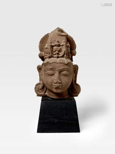 NORTH INDIA, CIRCA 12TH CENTURY A RED SANDSTONE HEAD OF A VAISHNAVAITE DEITY