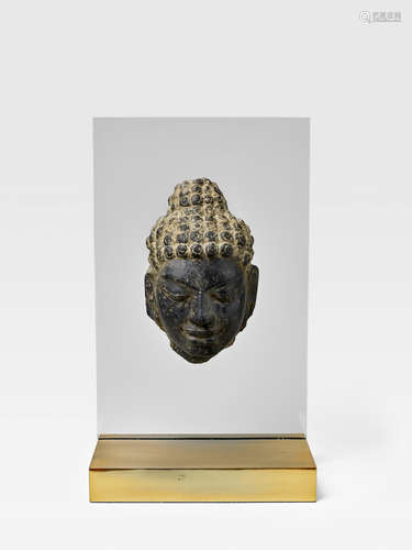 CENTRAL THAILAND, DVARAVATI PERIOD, CIRCA 8TH CENTURY A BLACKSTONE HEAD OF BUDDHA