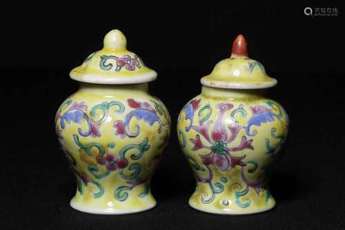 PAIR OF FAMILLE ROSE AND YELLOW GROUND 'FLOWERS' JARS WITH COVERS