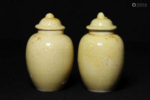 PAIR OF YELLOW GLAZED AND CARVED SMALL JARDINIERES WITH COVERS