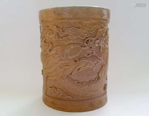 A Chinese Glazed Pottery Brush Pot Decorated With a Carved Dragon.