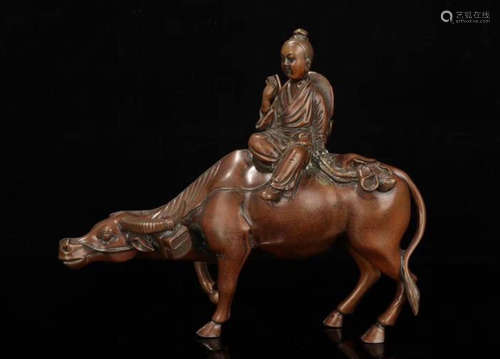 A BRONZE CASTED CHILD AND COW ORNAMENT