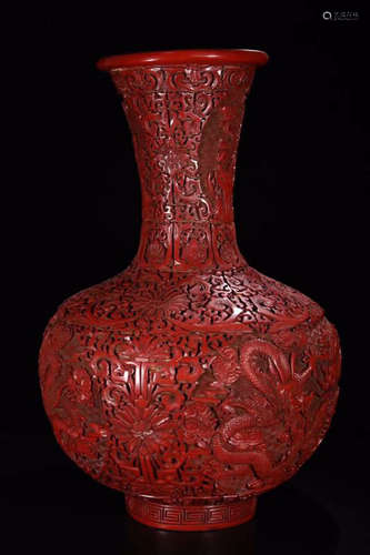 A RED LACQUER CARVED FLORAL DRAGON PATTERN VASE