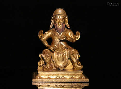 A GILT BRONZE FIGURE SHAPED ORNAMENT