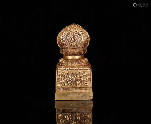 A GILT BRONZE MOLDED TIBETAN BUDDHIST SEAL