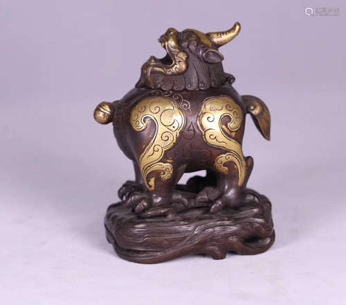 A GILT BRONZE MOLDED BEAST SHAPED FIGURE