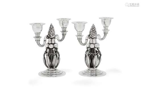 Georg Jensen, a pair of Danish silver Fir Cone twin light candelabra