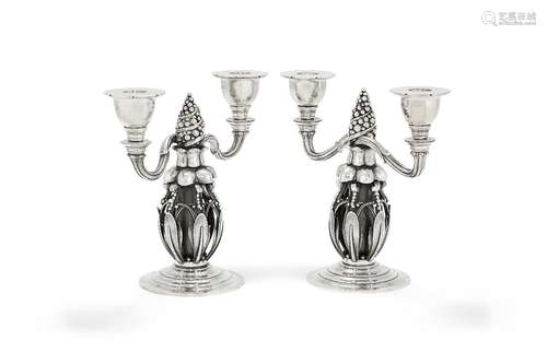 Georg Jensen, a pair of Danish silver Fir Cone twin light candelabra