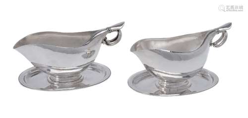 Georg Jensen, a pair of Danish silver sauce or gravy boats on integral stands