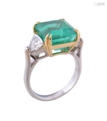 An emerald and diamond three stone ring