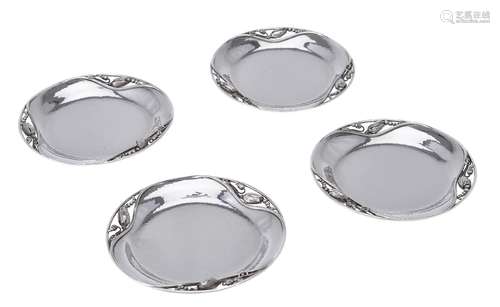 Georg Jensen, four Danish silver Blossom pattern coasters or bottle trays