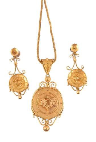 A mid Victorian archaeological revival gold pendant and ear pendants