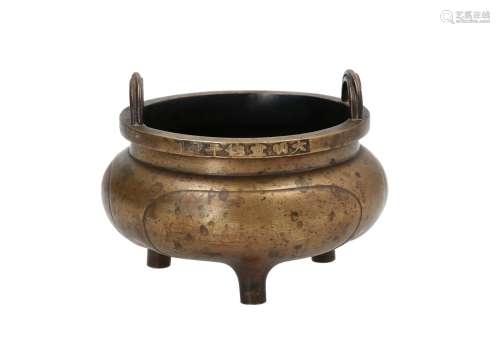 A tripod bronze censer with two handles. The base with a dragon in relief. Marked with 6-character