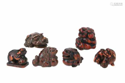 Lot of six netsuke, 1) Wooden shishi with temple bell on base. H. 3,5 cm. 2) Wooden shishi with ball