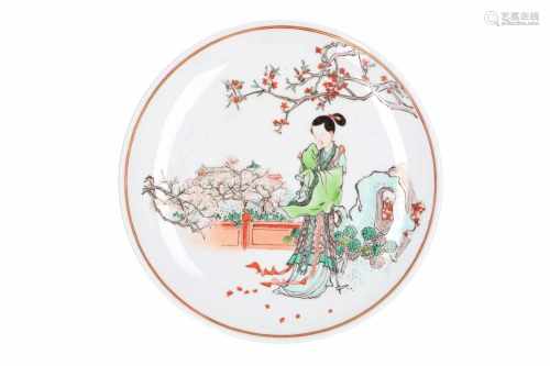 A polychrome porcelain dish, decorated with a lady in a garden. Marked with seal mark Yawan Zhen