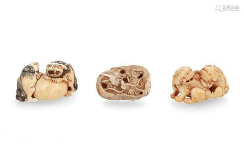 Lot of three netsuke, 1) Ivory, two shishi of which one with loose ball in mouth. Signed Tomokazu.