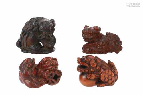 Lot of four netsuke, 1) Wooden shishi with ball and loose ball in mouth. L. 4 cm. 2) Wood with