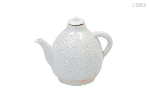 A white glazed porcelain jug, decorated in relief with swastika patterns. Unmarked. China, 17th
