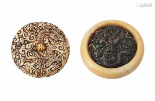 Lot of two manju, 1) Ivory with metal, decorated with dragon. Diam. 5,5 cm. 2) Ivory, decorated with