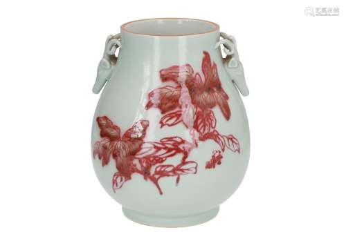 A celadon and underglaze red porcelain vase, decorated with flowers. The handles in the shape of