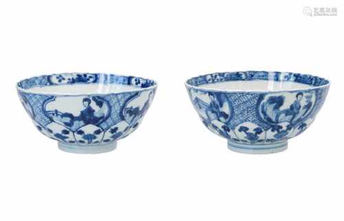 A pair of blue and white lotus shaped porcelain bowls, decorated with figures in a garden, flowers