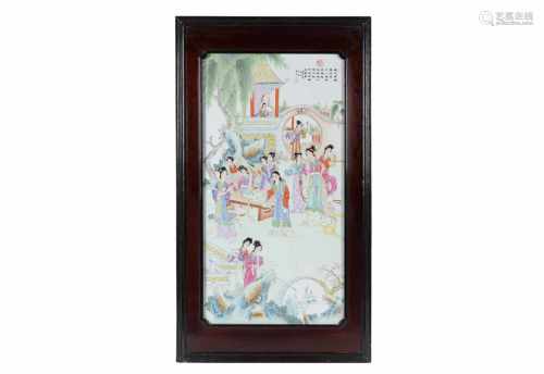 A polychrome porcelain plaque in wooden frame, depicting ladies in a garden and characters. Marked