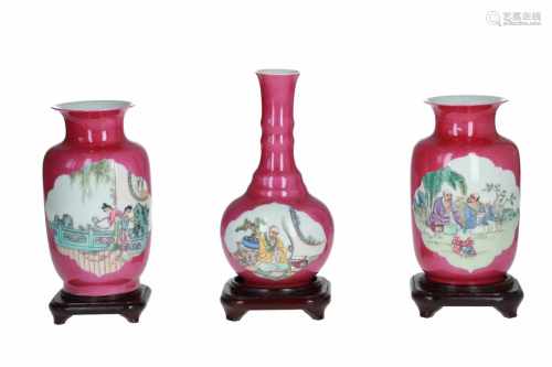 Lot of three polychrome porcelain vases on wooden bases, decorated with 1) sitting figures. H. excl.