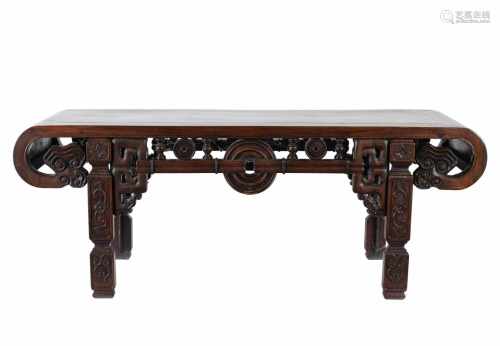 A carved rosewood table. China, 20th century. Dim. 118,5 x 40 x 45 cm.