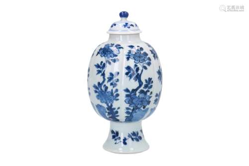 A blue and white porcelain tea caddy with ribbed belly, decorated with flowers. Marked with