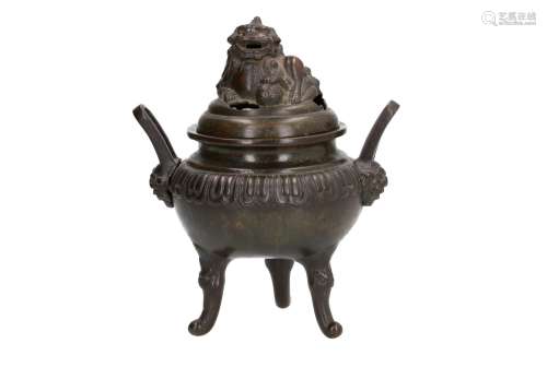 A bronze tripod censer with two handles. The lid with a handle in the shape of a lion with ball.
