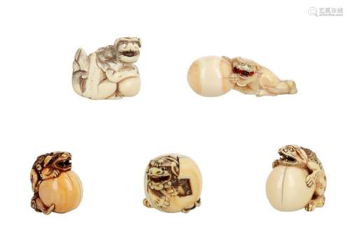 Lot of five netsuke, 1) Ivory reclining shishi with ball and loose ball in mouth. L. 5 cm. 2)