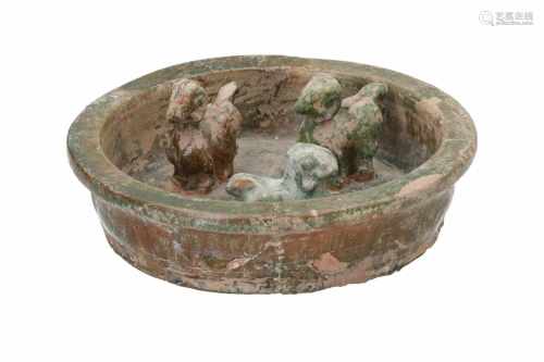 A green glazed earthenware sheep pen with three rams. China, eastern Han, 6 - 220 or later. H. 5,5