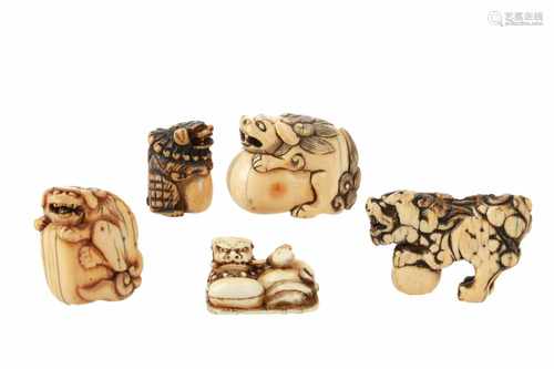 Lot of five netsuke, 1) Ivory shishi with ball. L. 4,5 cm. 2) Ivory reclining shishi with temple