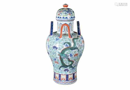 A polychrome porcelain lidded vase with four handles, decorated with dragons, flowers and