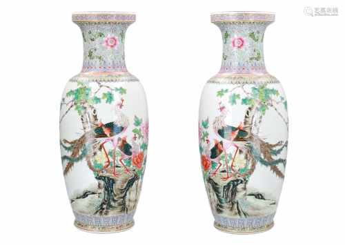 A pair of polychrome porcelain vases, decorated with birds, flowers and a poem. Marked with seal