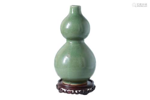 A celadon porcelain vase on wooden base. Unmarked. China, 18th/19th century. H. excl. base 31 cm.