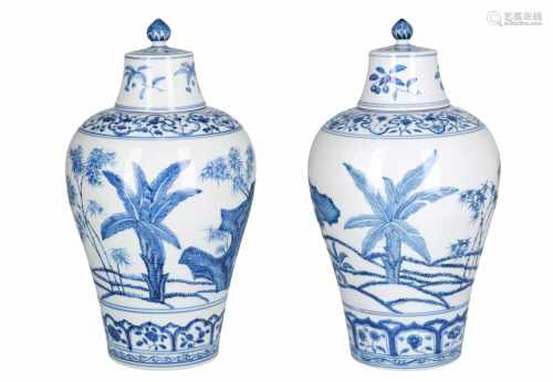 A pair of blue and white porcelain lidded vases, decorated with flowers. Marked with 4-character