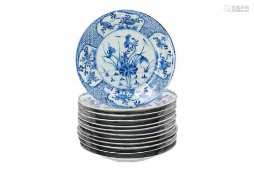 Lot of twelve blue and white porcelain dishes, decorated with flowers. Marked with Mandarin mark