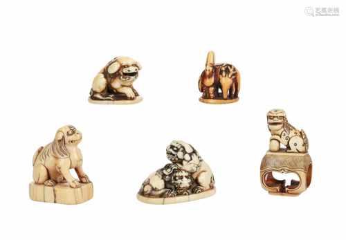 Lot of five netsuke, 1) Ivory seal netsuke, Fukurokuju with deer. H. 3 cm. 2) Ivory shishi on