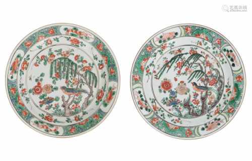 A pair of famille verte porcelain dishes, decorated with a singing bird amidst flowers. The rim with